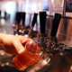 Pouring beer into glass from tap